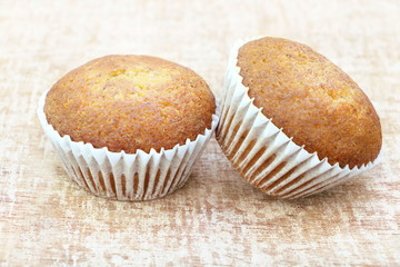 Close up two banana cup cake bakery, look delicious on wooden table background, vintage tone.