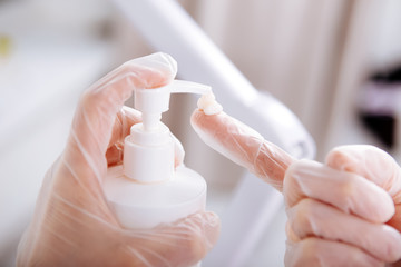 Depilatory master wearing gloves using moisturizing cream