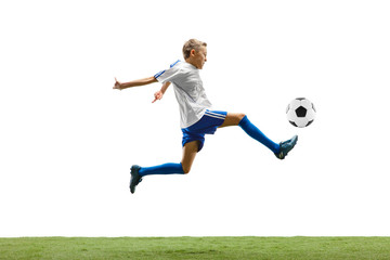 Fototapeta na wymiar Young boy with soccer ball running and jumping isolated on white studio background. Junior football soccer player in motion