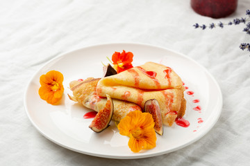 Fresh breakfast crepes with sauce on plate