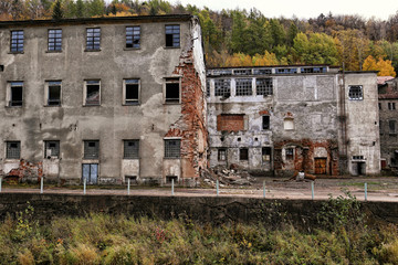 Unused broken abandoned factory buildings with wall remains