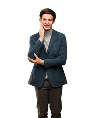 Teenager man with turtleneck surprised and shocked while looking right over isolated white background