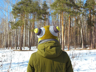 Girl against the winter forest. One man at the edge of the forest. Winter walk near the forest.