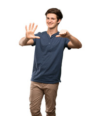 Naklejka premium Teenager man counting six with fingers over isolated white background