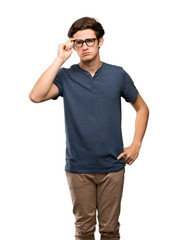 Fototapeta premium Teenager man with glasses and surprised over isolated white background