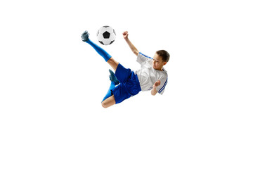 Young boy with soccer ball running and jumping isolated on white studio background. Junior football...