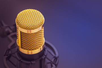 Close-up condenser gold microphone with luxury. Composition on the left side with free space on the right. Artistic style.