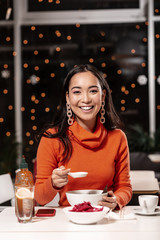Close up vertical portrait of girl talking to someone behind the camera.