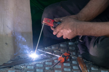 man using electric arc welder