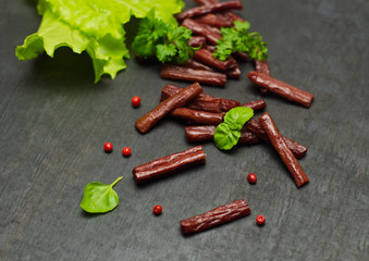 pieces of dried meat and a branch of parsley and pepper peas