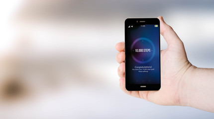 mobile phone steps counter on user´s hand