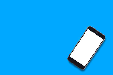 Single black smartphone with isolated blank white screen on blue background with copy space for your text. Top view