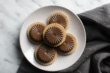 Chocolates on plate on marble background