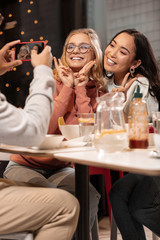 Amusing photos of girls on the phone after dinner in restaurant.