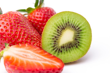 Halved kiwi fruit with strawberries on white