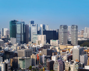 Obraz premium Landscape of tokyo city skyline in Aerial view with skyscraper, modern office building and blue sky background in Tokyo metropolis, Japan.
