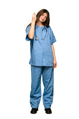 Full-length shot of Young nurse making Italian gesture on isolated white background