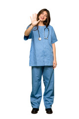 Full-length shot of Young nurse counting five with fingers on isolated white background