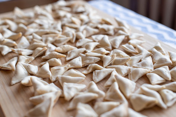 raw, uncooked triangle shaped manti. traditional turkish food. turkish ravioli