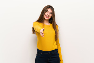 Young woman with yellow sweater shaking hands for closing a good deal