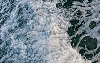Fototapeta na wymiar bubble and turbulent of wave ,Blue sea waves with a lot of sea foam