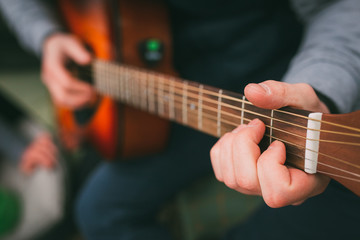 Fototapeta na wymiar Playing on the shitara. Guitar. Guy with a guitar in his hand