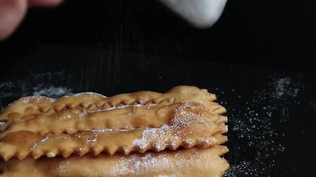 Carnival fritters topped with icing sugar, a typical Italian sweet of Carnival celebrations.