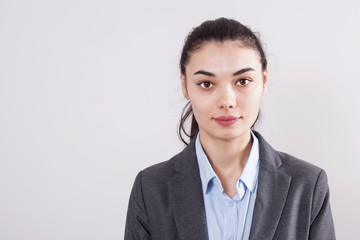 Young businesswoman on gray background