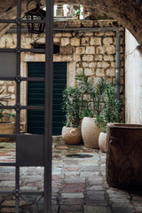 Old european courtyard with achient vases and door