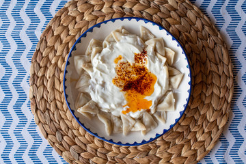Manti, traditional Turkish food. Turkish Ravioli. Served with yoghurt and butter sauce.