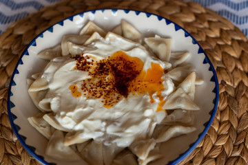Manti, traditional Turkish food. Turkish Ravioli. Served with yoghurt and butter sauce.