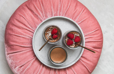 vegan Chocolate dessert with raspberries on marble background with copy space