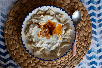 Manti, traditional Turkish food. Turkish Ravioli. Served with yoghurt and butter sauce.