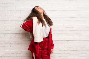 Teenager sport girl with curly hair suffering from backache for having made an effort