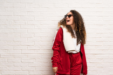 Teenager sport girl with curly hair with glasses and smiling