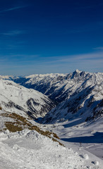 Fototapeta na wymiar view from the highest accessible point to the slopes and ravine in the Kingdom of snow Stubaier Gletscher ski resort in the Stubai valley, Tirol, Austria