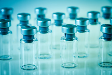 Vaccine glass bottles on blue background