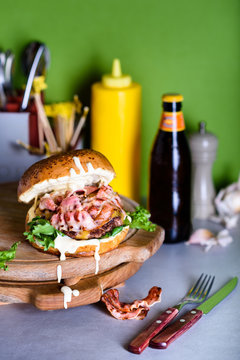 Bacon Burger With Aioli Sauce On A Wooden Board, Close Up.