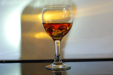 brandy in a glass on a black glass with reflection
