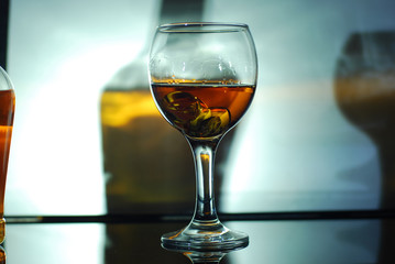 brandy in a glass on a black glass with reflection