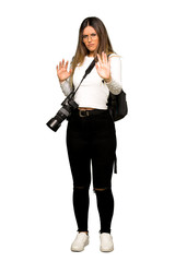 Full body of Young photographer woman is a little bit nervous and scared stretching hands to the front