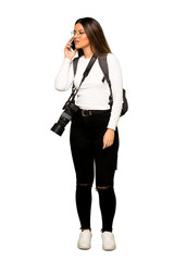 Full body of Young photographer woman using mobile phone