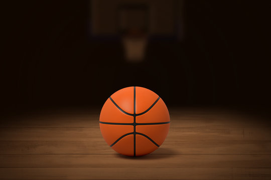 3d rendering of a basketball on the wooden floor in a dimly lit gym with a blurred image of the basket in the background.