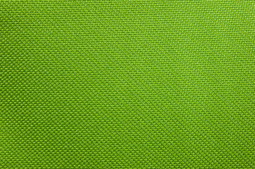 Texture of dense bright green fabric used in thermo bags