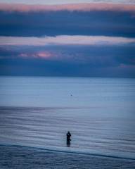 Fototapeta na wymiar Fisher fishing in Brittany in France at dusk