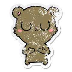 distressed sticker of a peaceful cartoon bear cub