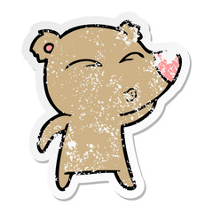 distressed sticker of a cartoon whistling bear