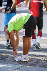 Fototapeta na wymiar Warm-up and Stretching of Leg Muscles before a Marathon in the City