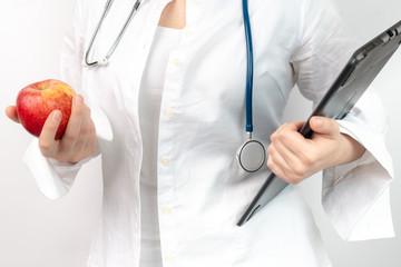 doctor with stethoscope and apple