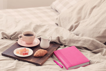 coffee in pink cup on tray in bedroom